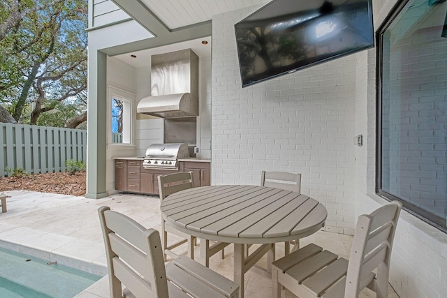 view of patio / terrace featuring outdoor dining area, area for grilling, and fence