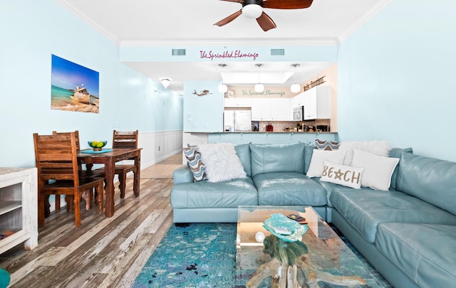 living room featuring crown molding, ceiling fan, and wood-type flooring