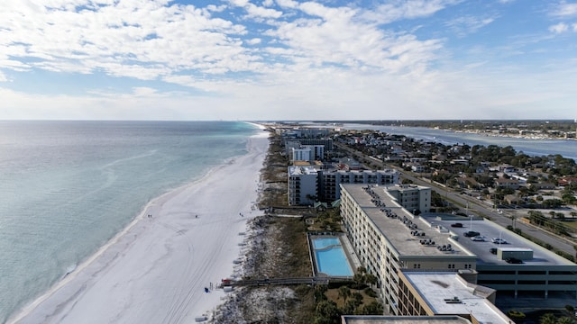 birds eye view of property with a water view and a beach view