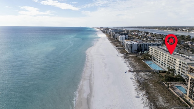 bird's eye view with a water view and a beach view