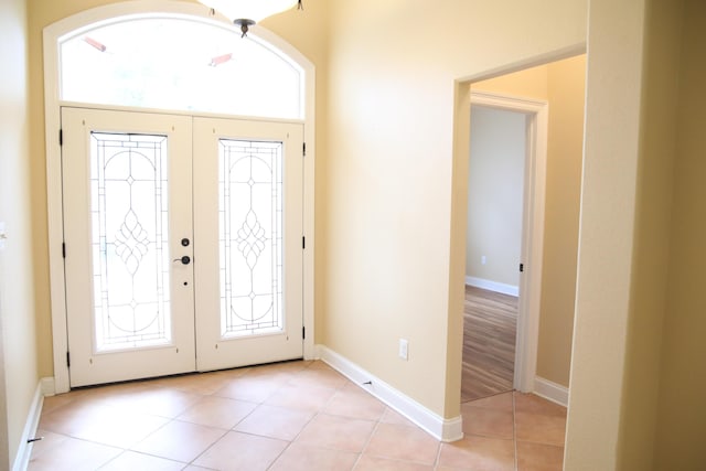 foyer featuring light tile patterned floors and french doors