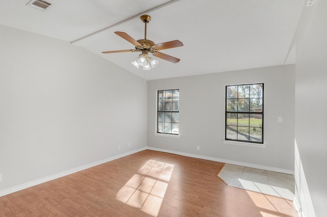 empty room with light wood-type flooring, ceiling fan, and lofted ceiling