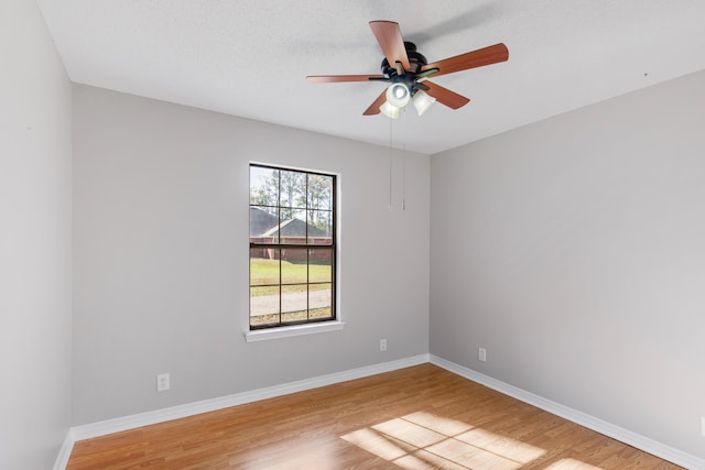 unfurnished room featuring ceiling fan and hardwood / wood-style flooring