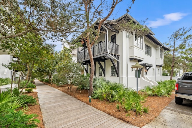 view of side of home featuring a balcony