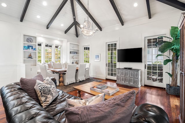 living room featuring vaulted ceiling with beams, dark hardwood / wood-style flooring, built in features, and a wealth of natural light