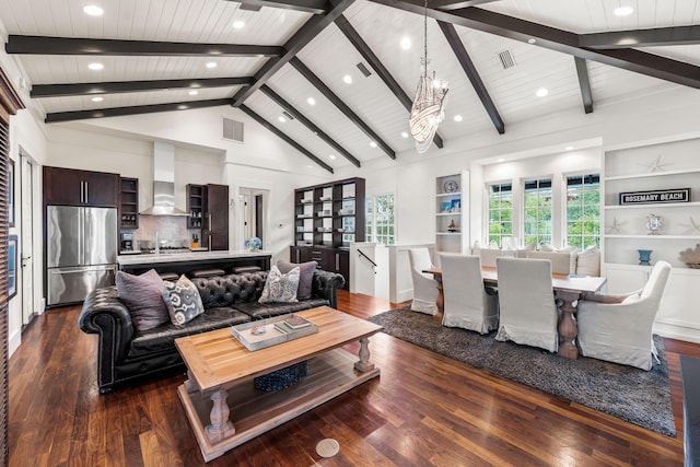 living room featuring dark hardwood / wood-style flooring, high vaulted ceiling, built in features, and a notable chandelier