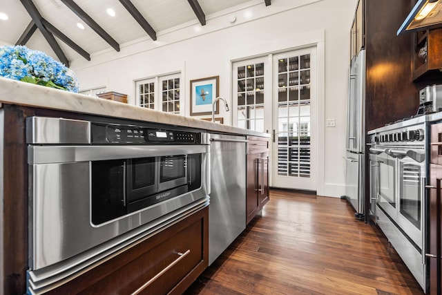 kitchen with french doors, vaulted ceiling with beams, dark hardwood / wood-style floors, wood ceiling, and appliances with stainless steel finishes