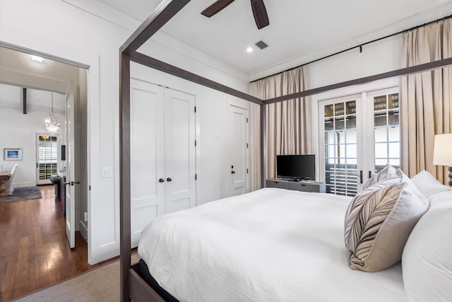 bedroom with beam ceiling, ceiling fan, and dark wood-type flooring