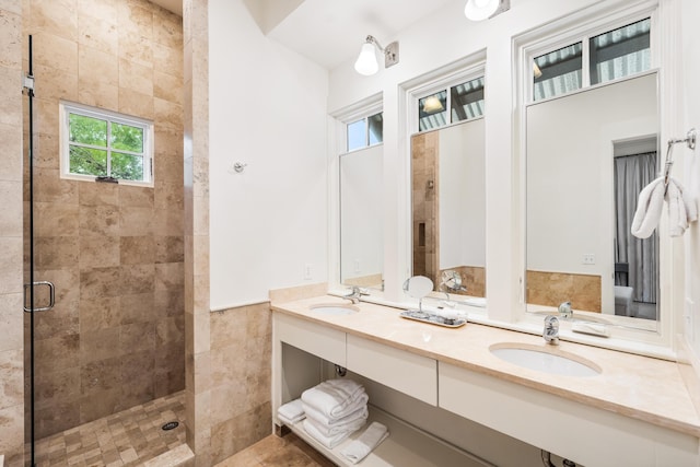 bathroom with vanity, walk in shower, and tile walls