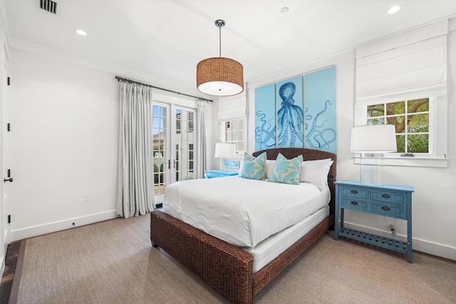 carpeted bedroom featuring crown molding