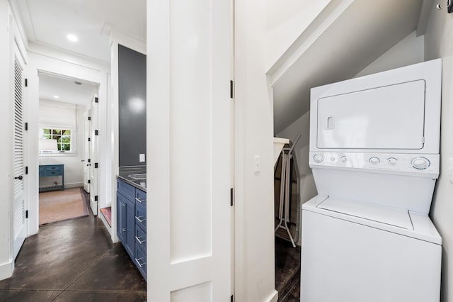 laundry area with stacked washer / drying machine