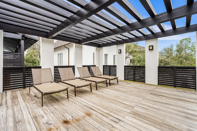 wooden terrace with a pergola and outdoor lounge area