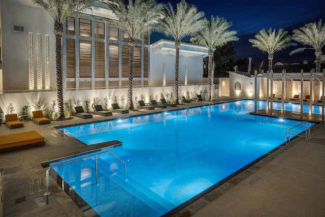 pool at night with a patio