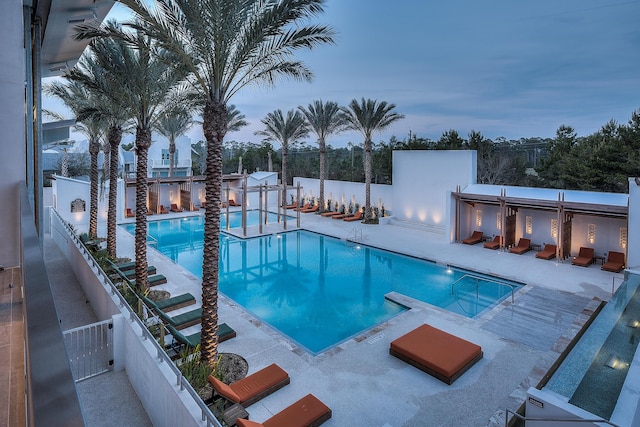 view of pool at dusk