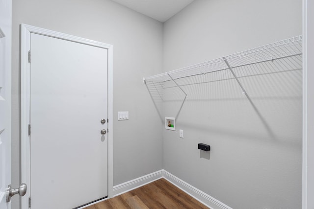 clothes washing area featuring laundry area, hookup for a washing machine, baseboards, and wood finished floors