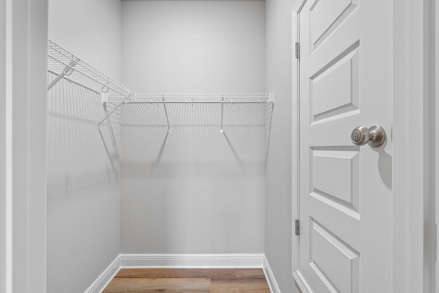 spacious closet with wood finished floors