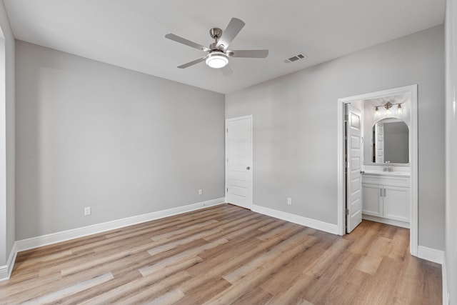 unfurnished bedroom featuring light wood-style floors, visible vents, and baseboards