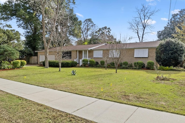 single story home with a front yard and a garage