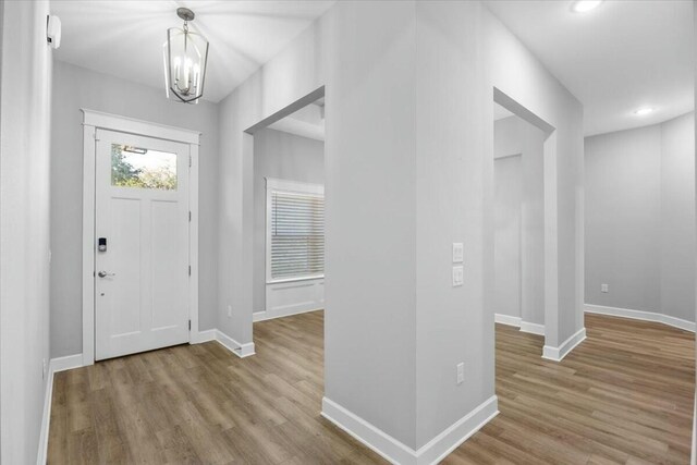 foyer entrance featuring a notable chandelier and light hardwood / wood-style floors