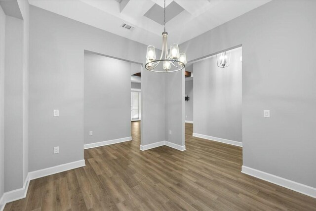 unfurnished dining area with dark wood-type flooring and a chandelier