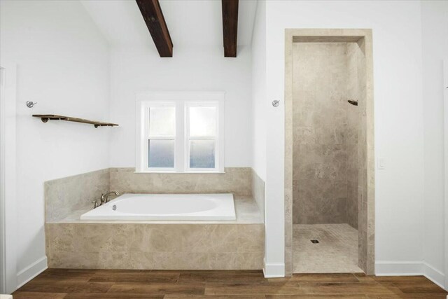 bathroom with hardwood / wood-style floors, beam ceiling, and plus walk in shower