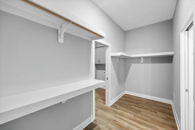 spacious closet featuring hardwood / wood-style flooring