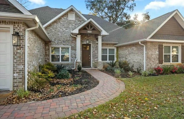 craftsman house featuring a garage and a front lawn