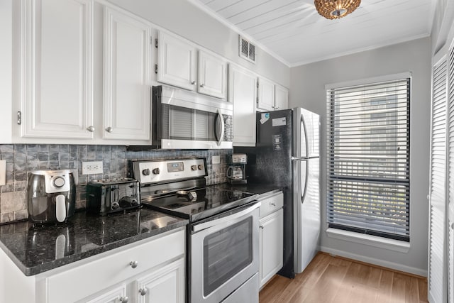 kitchen with backsplash, white cabinetry, a healthy amount of sunlight, and appliances with stainless steel finishes