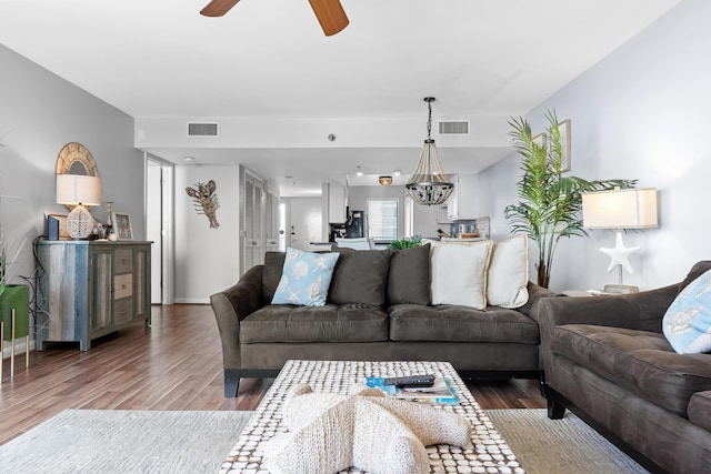 living room featuring ceiling fan and wood-type flooring