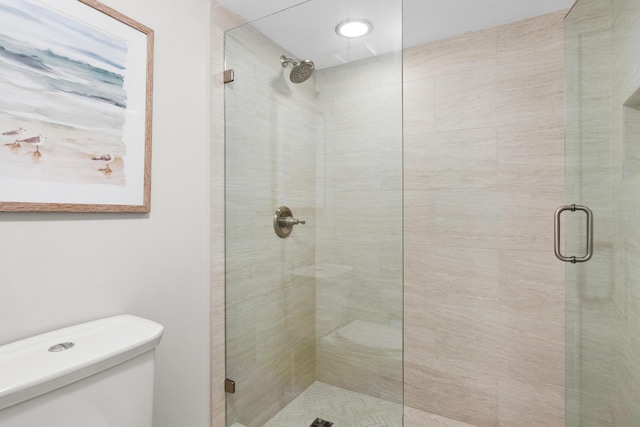 bathroom with an enclosed shower and toilet