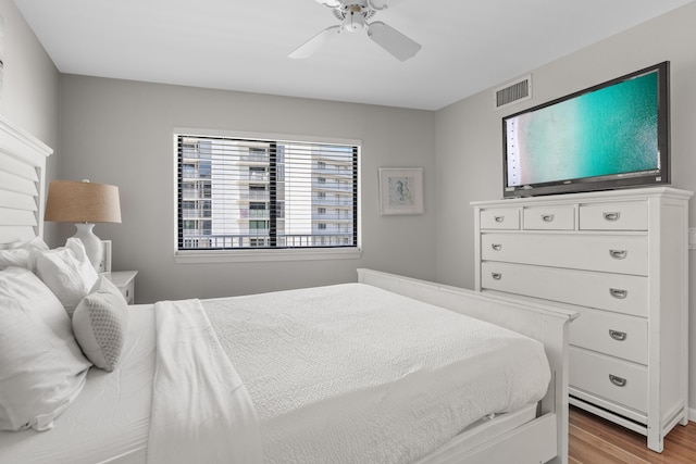 bedroom with light hardwood / wood-style floors and ceiling fan