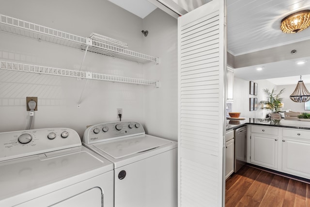 clothes washing area with dark hardwood / wood-style flooring and washer and clothes dryer