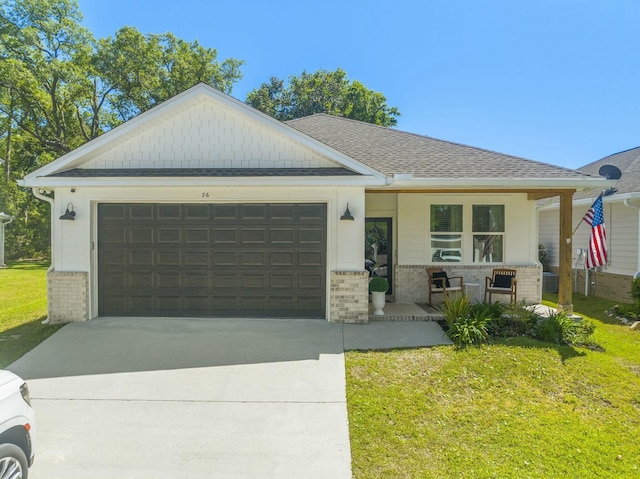 view of front of house with a garage, covered porch, and a front lawn