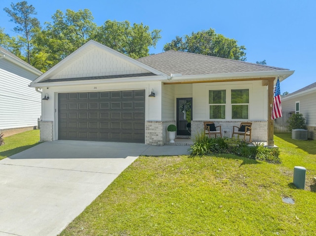 view of front facade featuring a porch, a garage, a front lawn, and central air condition unit