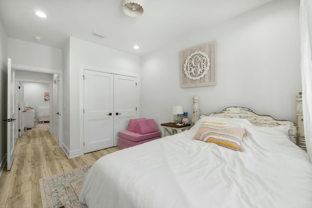 bedroom featuring light wood-type flooring and a closet