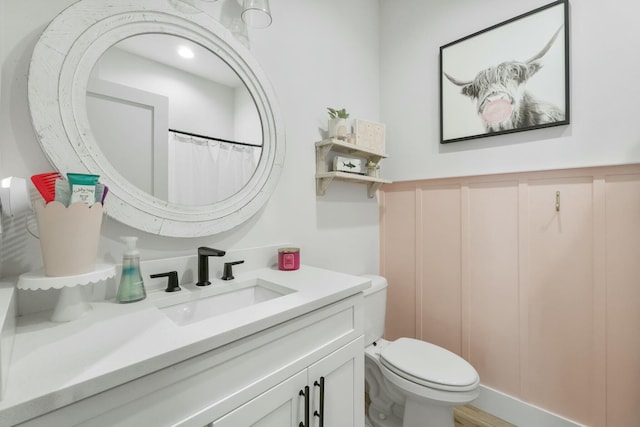 bathroom featuring vanity and toilet