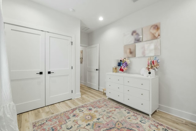 bedroom with a closet and light hardwood / wood-style flooring