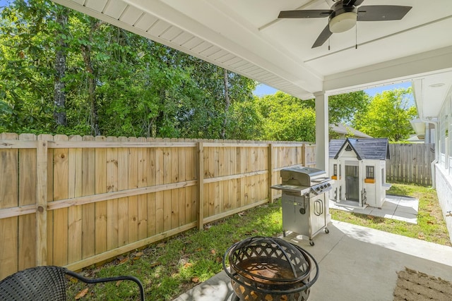 view of patio / terrace with a shed and grilling area