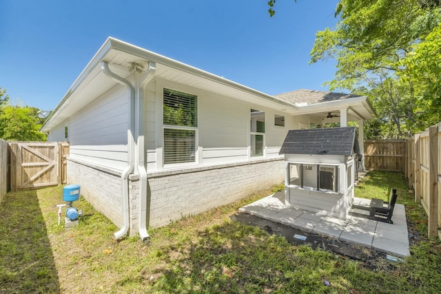 rear view of house featuring a yard and a patio