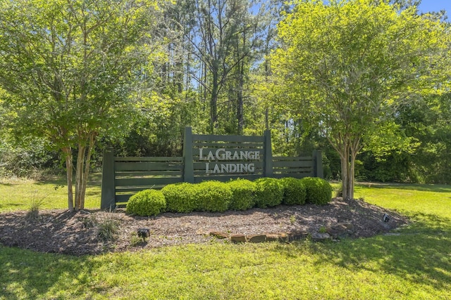 community / neighborhood sign with a lawn