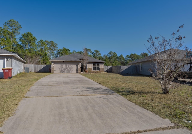 view of front facade featuring a front yard, central AC, and a garage