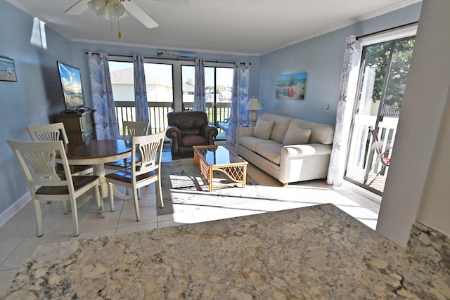 tiled living room featuring ceiling fan, crown molding, and french doors