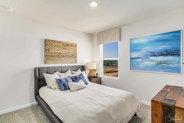 carpeted bedroom with a textured ceiling