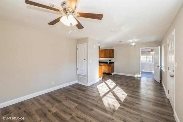 unfurnished living room featuring dark wood-type flooring