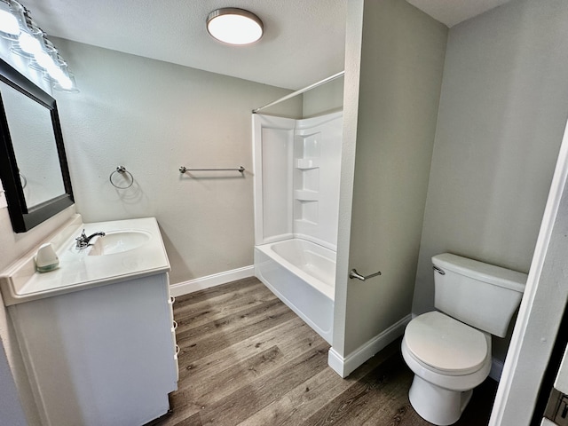 full bathroom featuring hardwood / wood-style flooring, vanity, shower / bath combination, and toilet