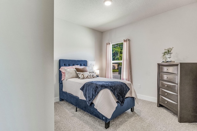 carpeted bedroom featuring a textured ceiling