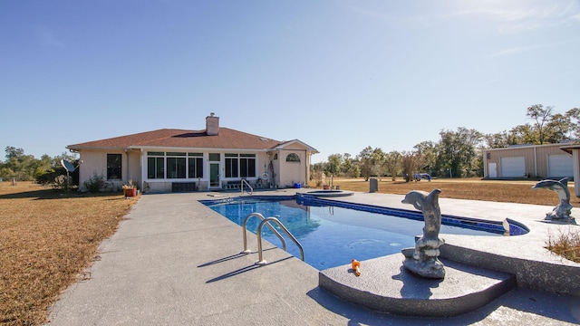 view of pool with a patio area and an in ground hot tub