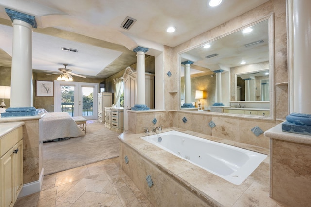 bathroom with ceiling fan, decorative columns, tiled bath, and french doors