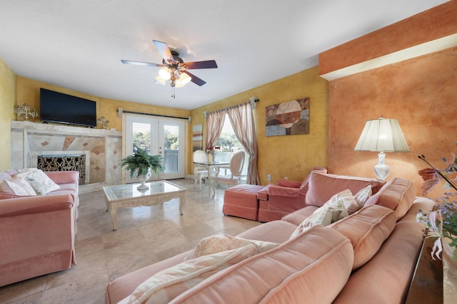 living room featuring french doors, ceiling fan, and a premium fireplace