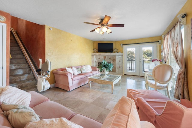 living room featuring ceiling fan and french doors